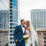 bride kissing groom at Deck655 rooftop ceremony